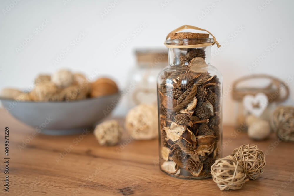 The potpourri in glass bottle on a wood table, provides a relaxing scent and great home fragrance
