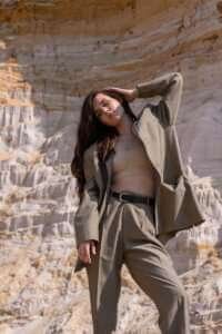 woman in brown cropped top and brown blazer posing fall fashion