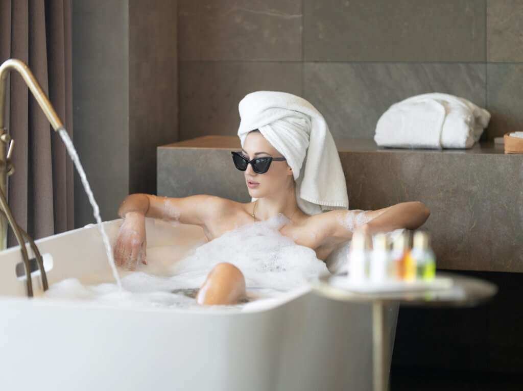 woman in white bath tub having a relaxing day 