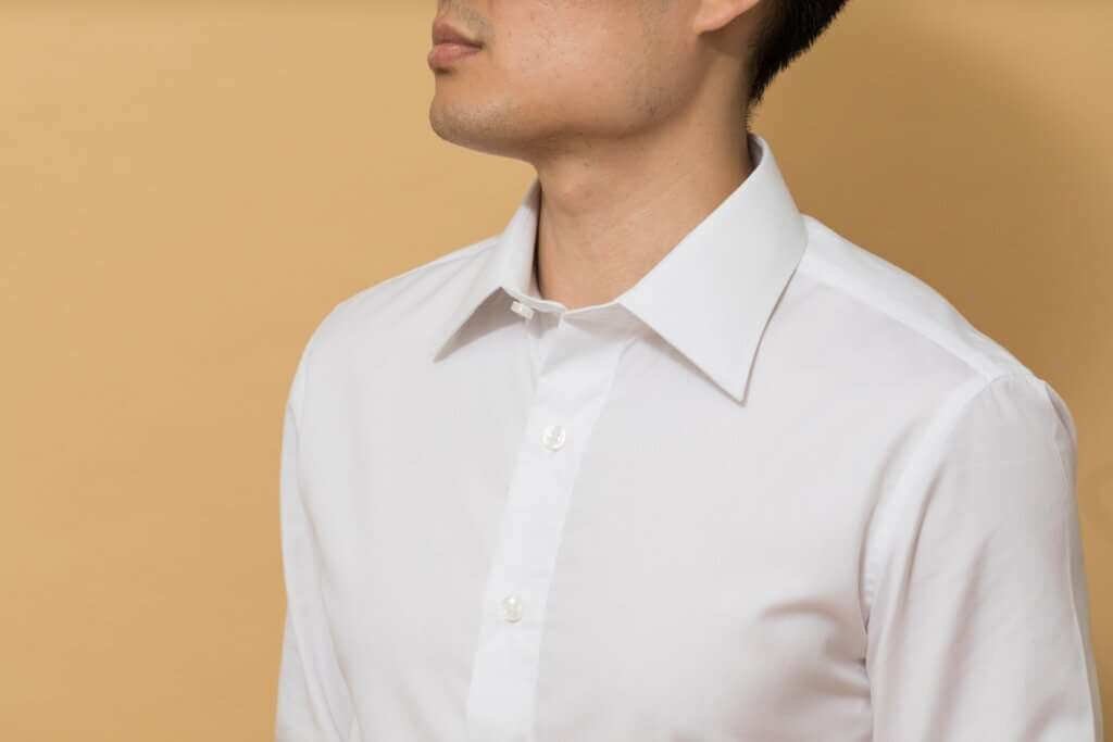 man in white button up shirt capsule wardrobe essential 